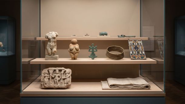 Museum vitrine of body-related artifacts from cultures around the world, illustrating how ideals of the human form have changed across history.