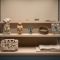 Museum vitrine of body-related artifacts from cultures around the world, illustrating how ideals of the human form have changed across history.