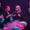 Men and women at a pheromone party smelling T-shirts and meeting through scent-based matchmaking.