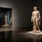 Classical male statue and modern gym mirror showing how culture shapes the ideal male body